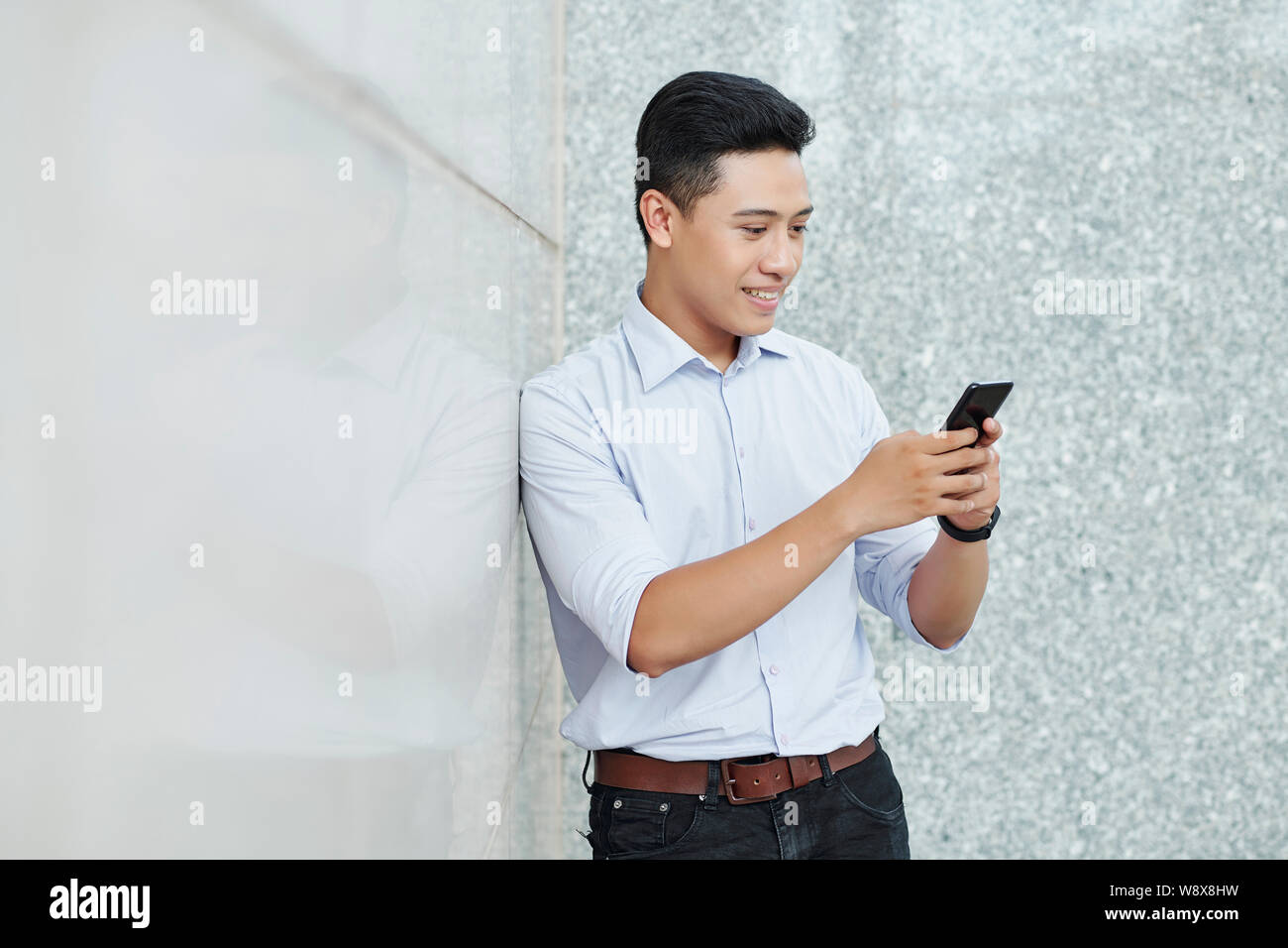 Smiling texting businessman Stock Photo
