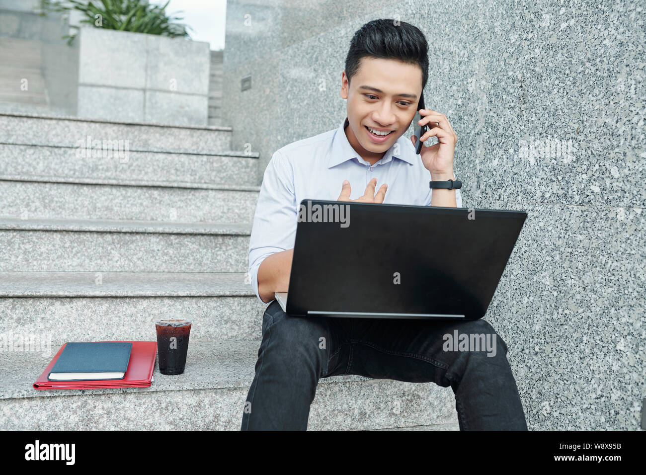 University student sitting on steps Stock Photo
