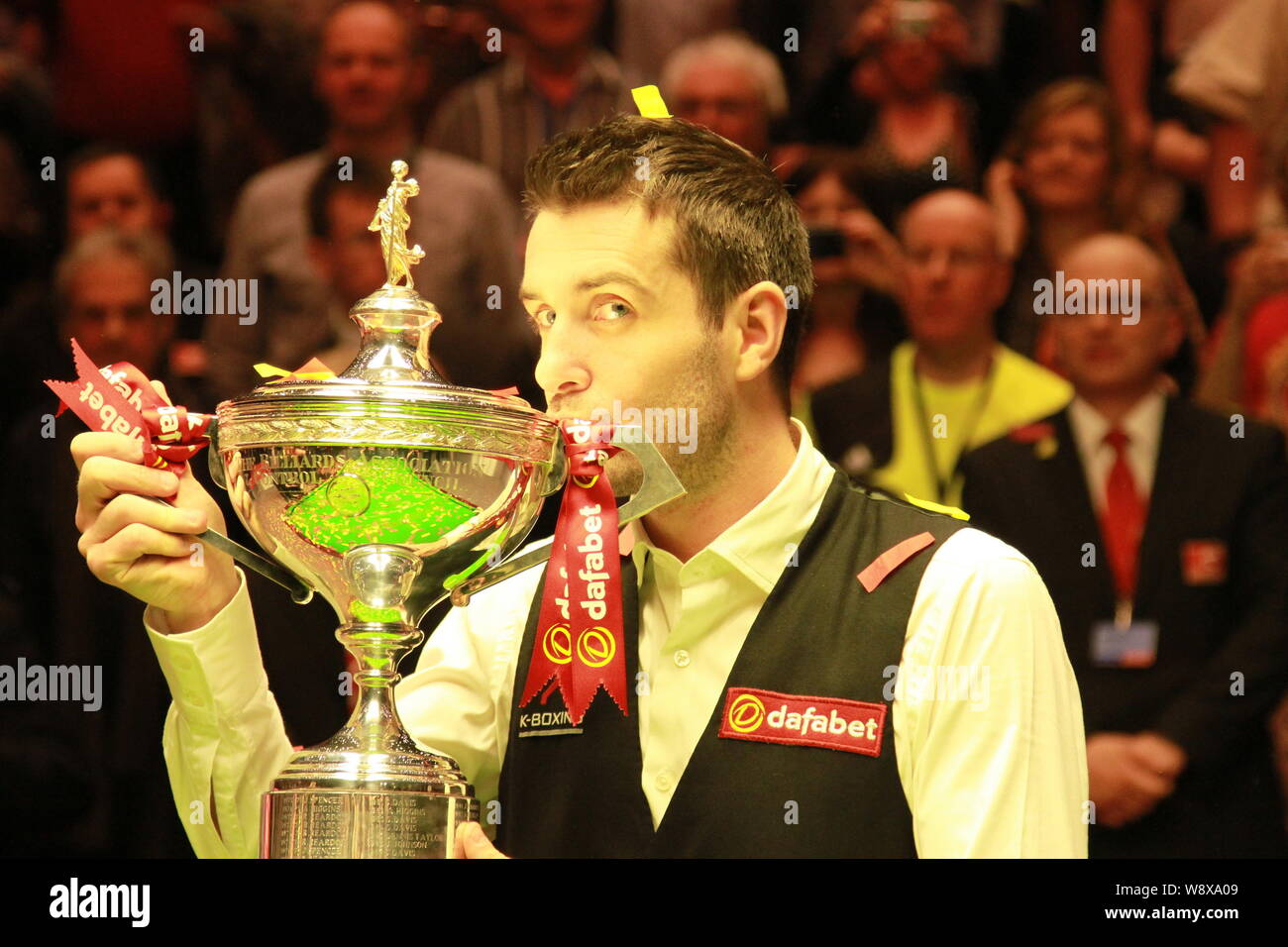 Mark Selby of England kisses his champion trophy after defeating Ronnie