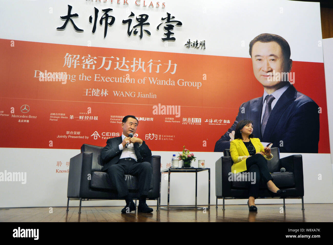 Wang Jianlin, left, Chairman of Dalian Wanda Group, speaks during a Master Class to mark the 20th anniversary of the China Europe International Busine Stock Photo