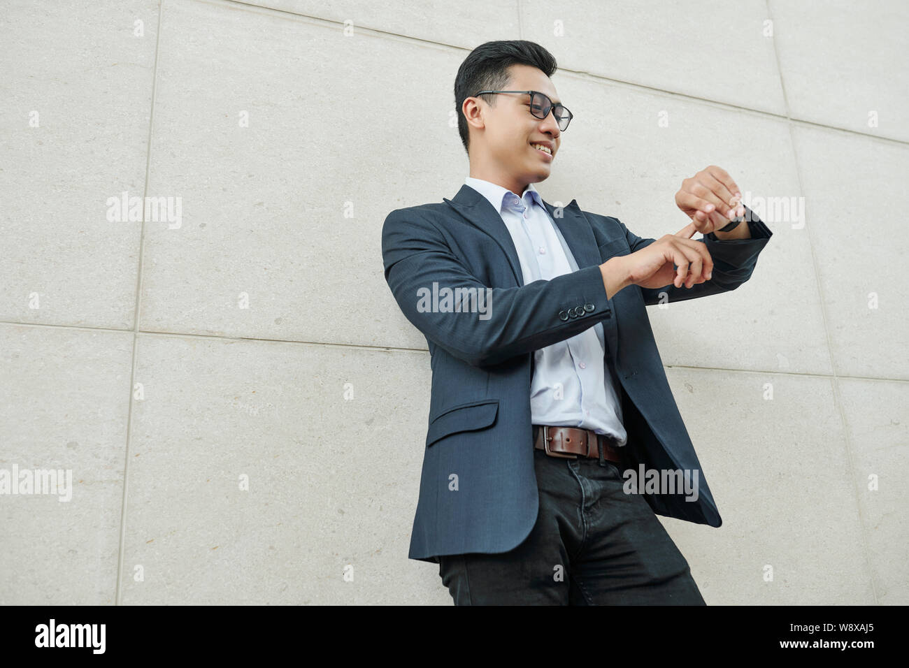 Asian businessman checking time hi-res stock photography and images - Alamy