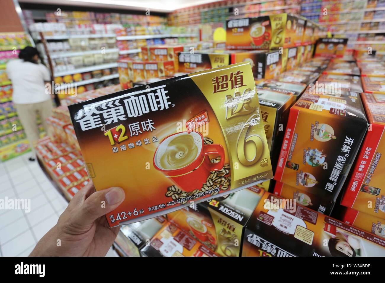 --FILE--A customer buys Nescafe coffee of Nestle at a supermarket in Xuchang city, central Chinas Henan province, 7 July 2013.    Swiss food giant Nes Stock Photo