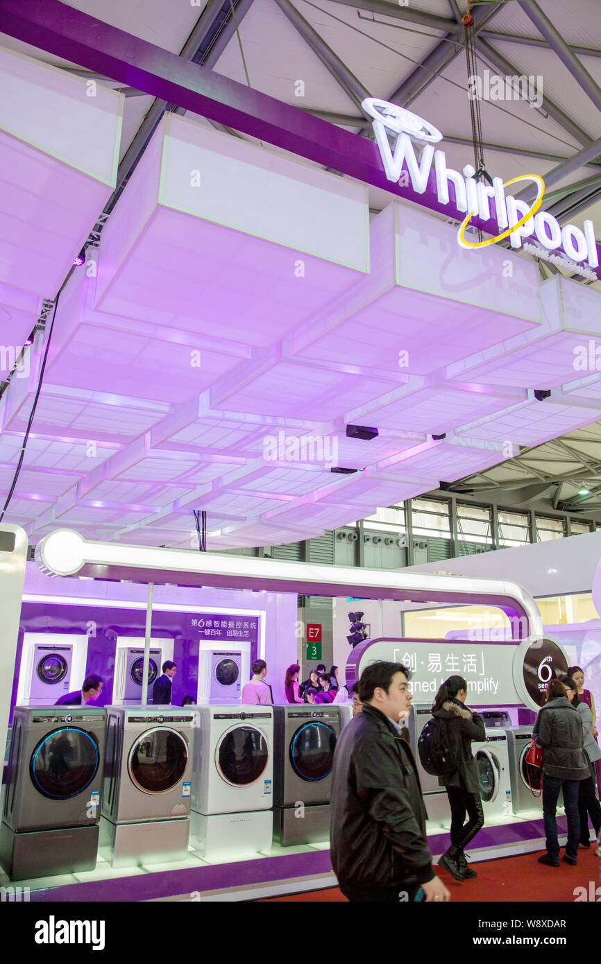 --FILE--Visitors look at Whirlpool washing machines during an exhibition in Shanghai, China, 20 March 2014.     Whirlpool Corp., hurt by falling sales Stock Photo