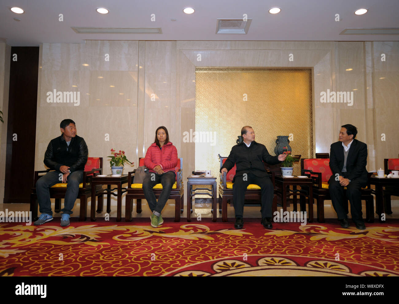 Chinese tennis star Li Na, second left, the winner of the 2014 Australian Open, and her husband Jiang Shan, left, sit next to officials during a welco Stock Photo