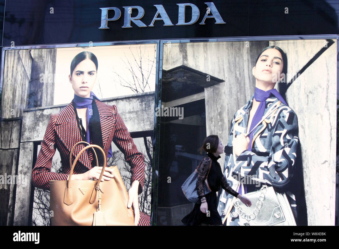 --FILE--A pedestrian walks past a boutique of Prada in Shanghai, China, 22 September 2014.   Italian fashion group Prada reported worse than expected Stock Photo