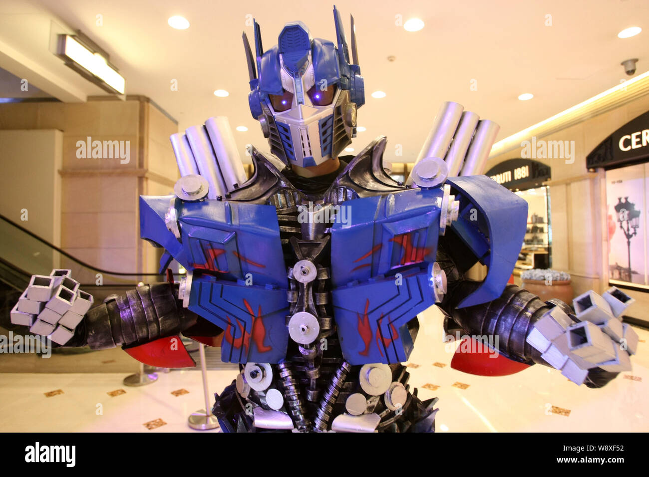 A performer dressed in his Transformers costume poses during a