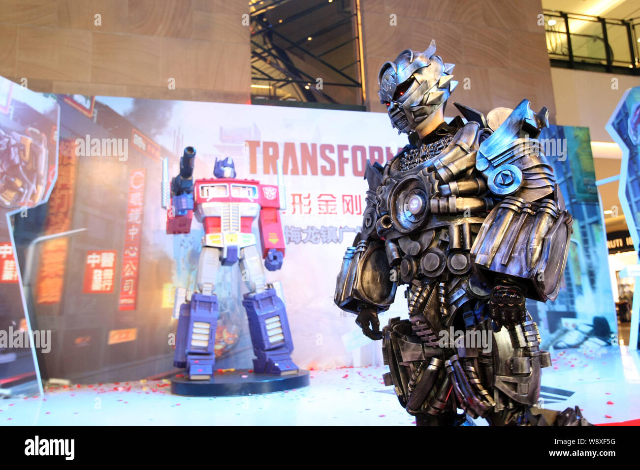 A performer dressed in his Transformers costume poses during a