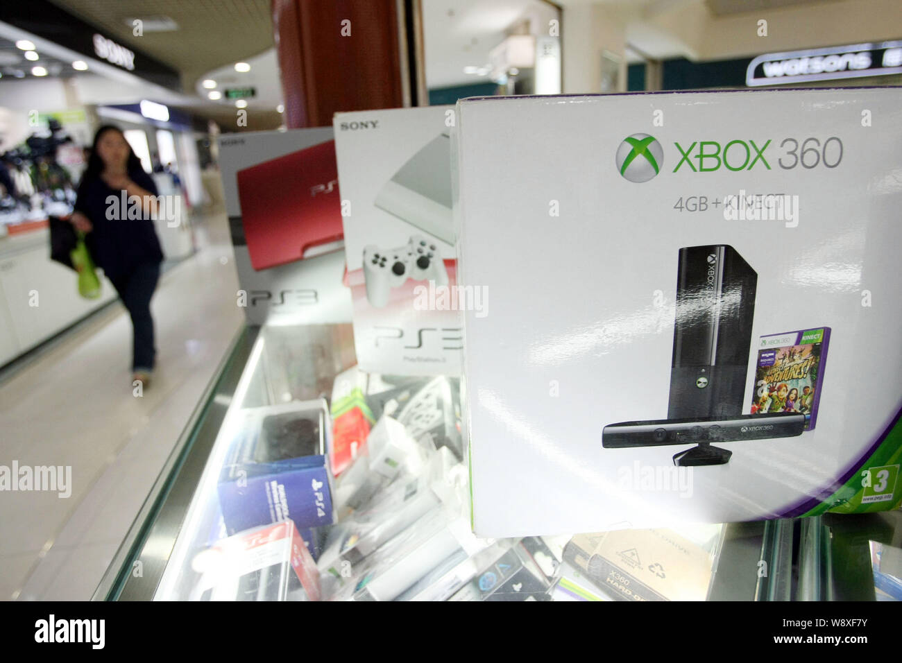 FILE--Microsoft XBOX 360 and Sony PS3 game consoles are for sale at a stall  in a digital products mall in Shanghai, China, 29 May 2014. JD.com In Stock  Photo - Alamy
