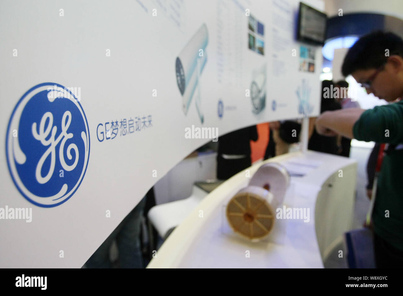 --FILE--People visit the stand of GE (General Electric) during an exhibition in Shanghai, China, 5 June 2013.   General Electric Co.'s China head expe Stock Photo