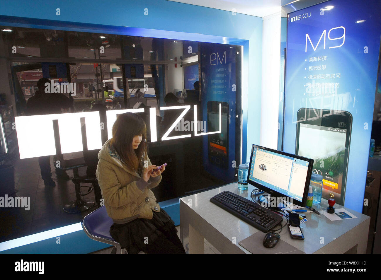 --FILE--A Chinese customer tries out a Meizu M9 smartphone at a store of Meizu in Shanghai, China, 5 January 2011.   Top Chinese smartphone maker Meiz Stock Photo