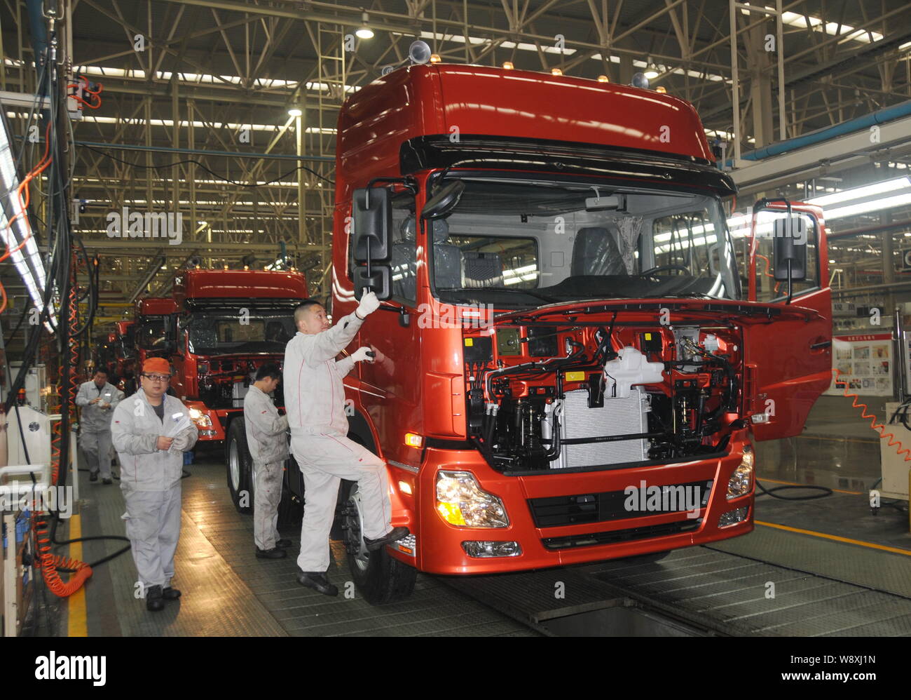 --FILE--Chinese workers assemble a truck on the assembly line of heavy ...