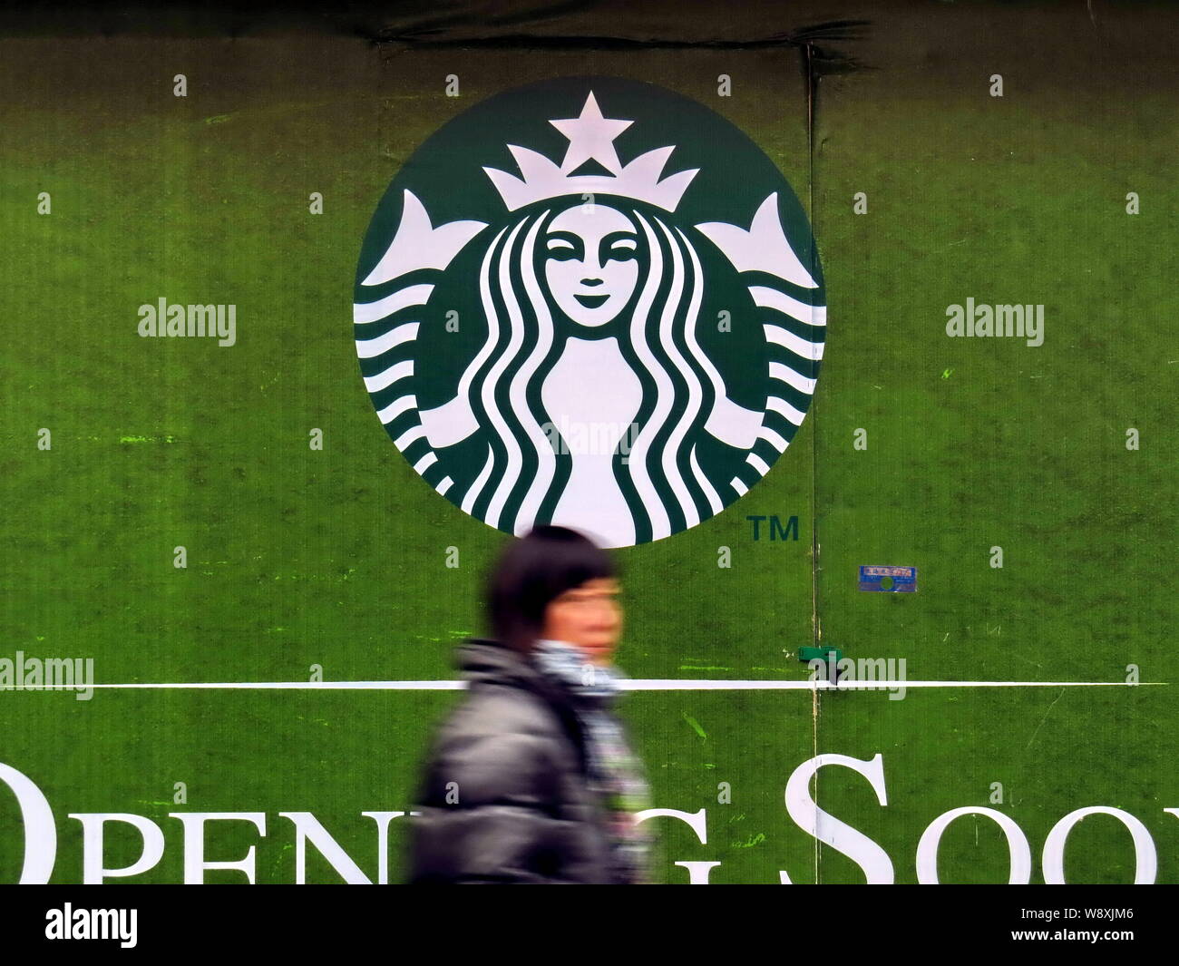 FILEA pedestrian walks past advertisement for Starbucks Coffee in