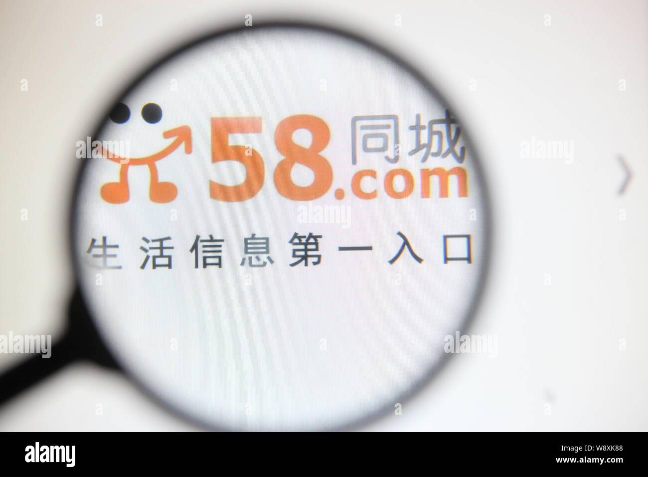 --FILE--A Chinese netizen looks at a logo of online classified site 58 ...