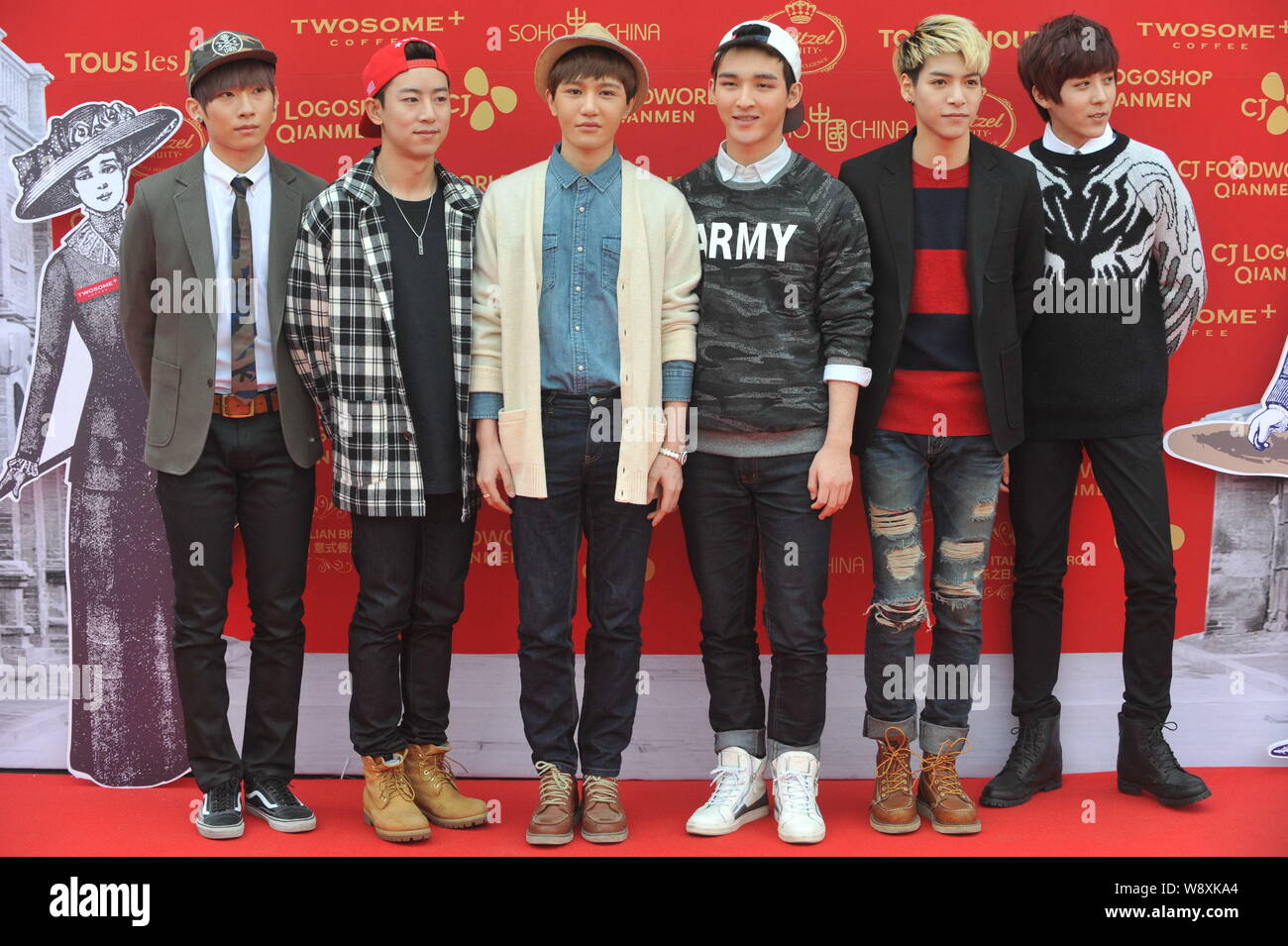 Members of Chinese-Korean pop group TIMEZ pose as they arrive for the