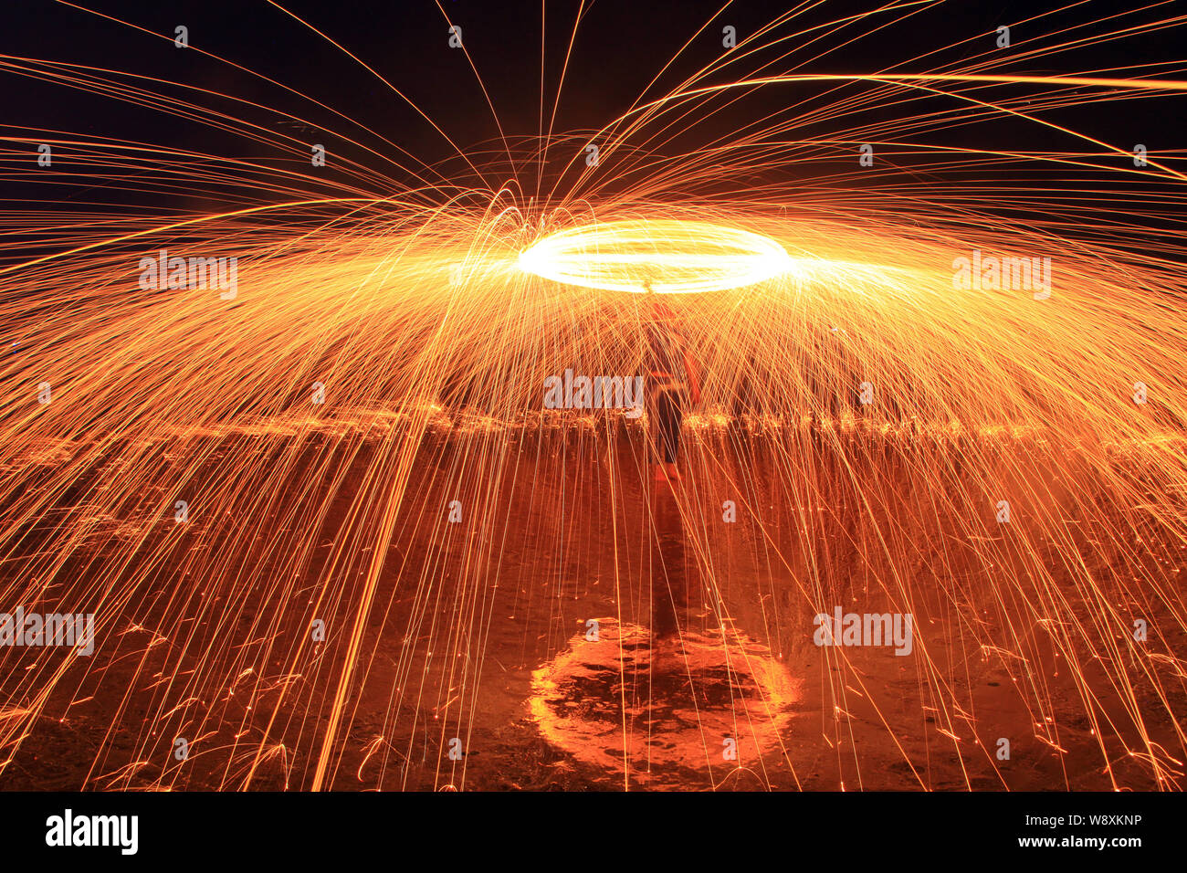 In this longexposure picture, a tourist whirls fireworks to splash