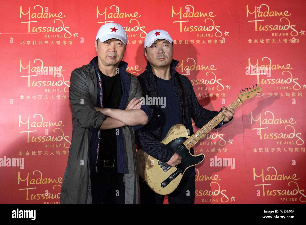 Chinese singer-songwriter Cui Jian, left, poses with the wax figure of