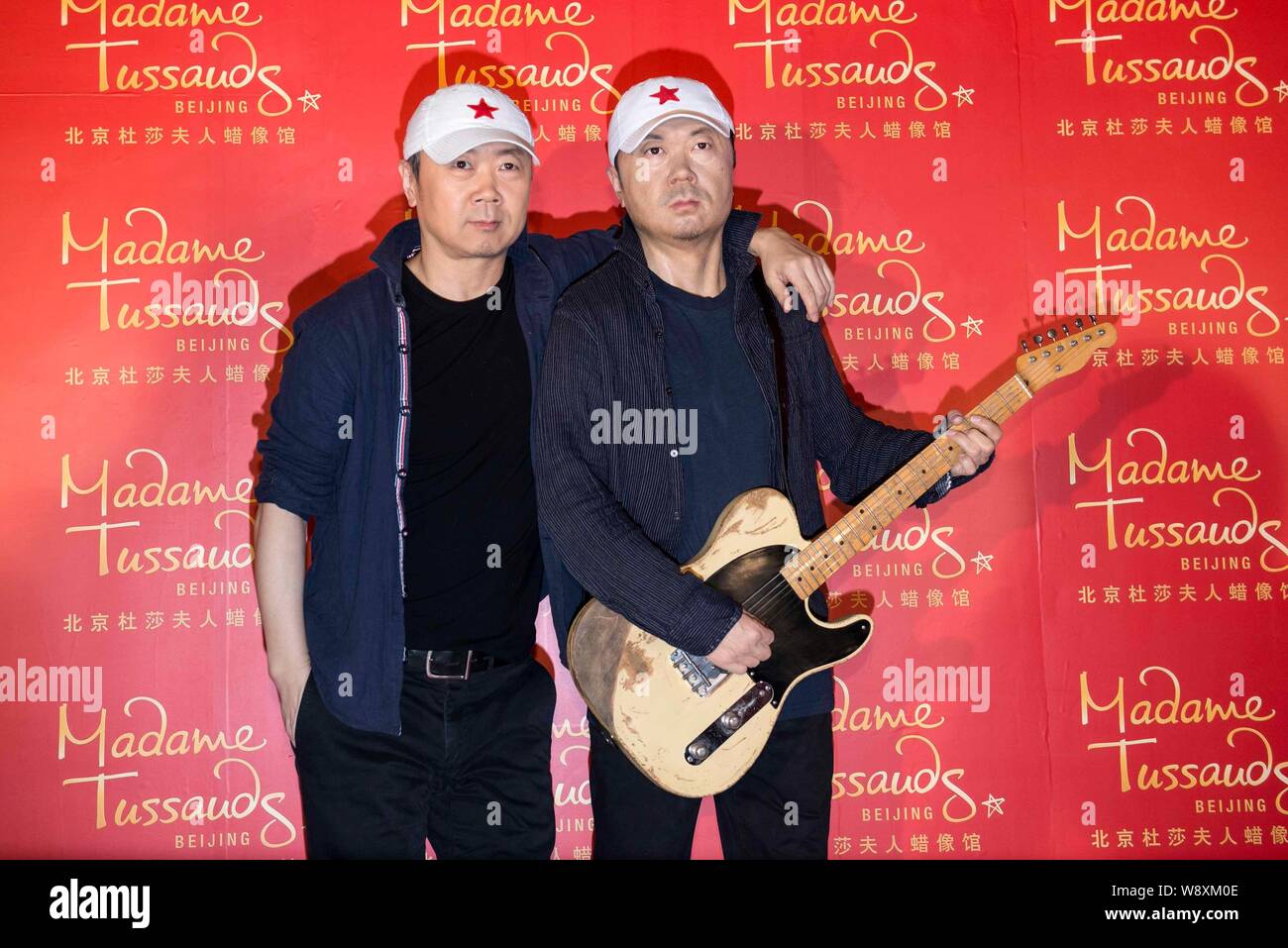 Chinese singer-songwriter Cui Jian, left, poses with the wax figure of