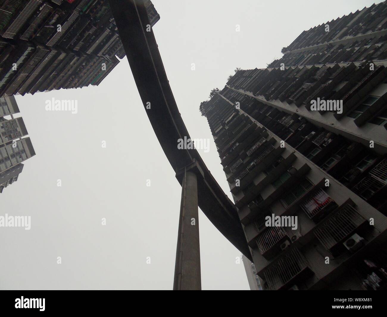 Worm's eye view of the pedestrian bridge linking the 13th floor of a building with the street below in Chongqing, China, 15 December 2014.   Pictures Stock Photo