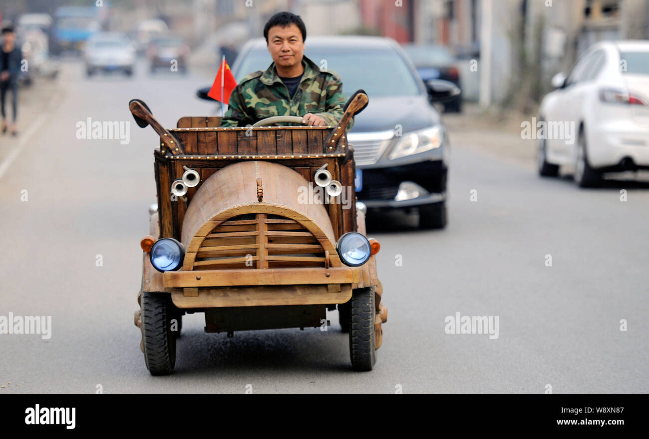 Chinese carpenter Liu Fulong drives his homemade wooden electric car on
