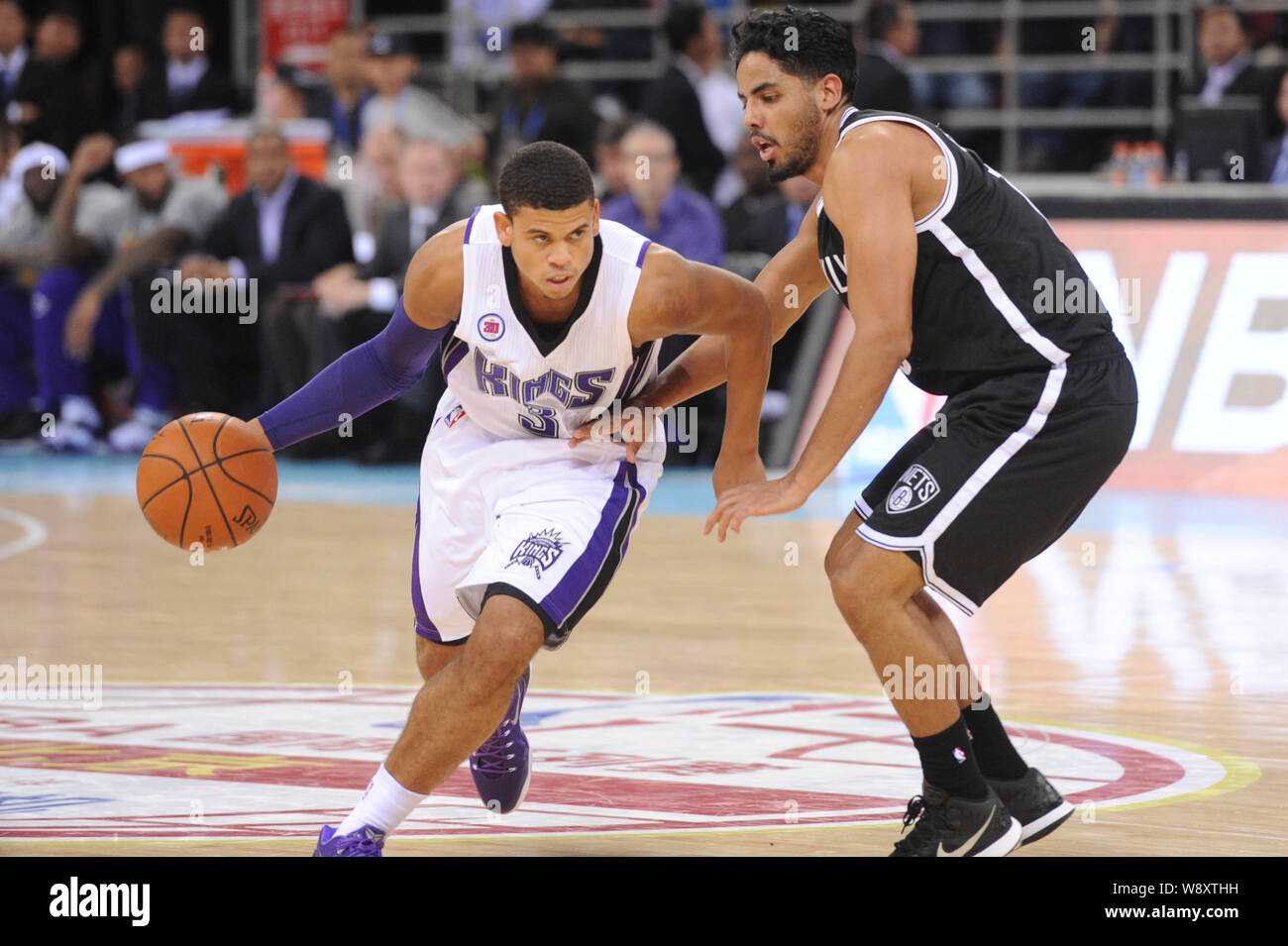 Ray McCallum of Sacramento Kings, left, challenges Jorge Gutierrez of Brooklyn Nets during an NBA exhibition game in Beijing, China, 15 October 2014. Stock Photo