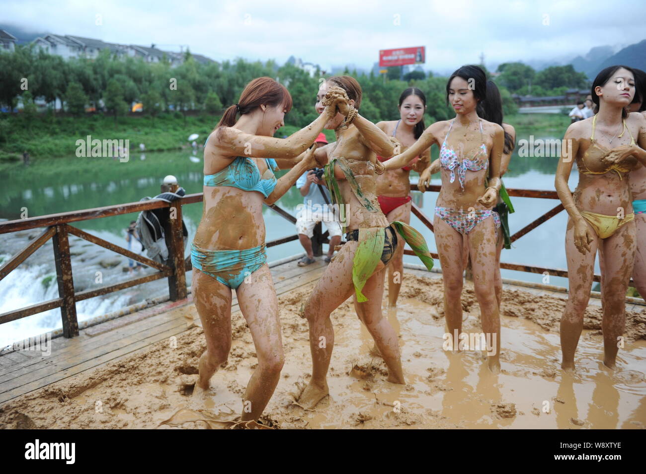 Bikini-dressed women have fun at a mud-wrestling event in a scenic area of Wulingyuan in Zhangjiajie city, central Chinas Hunan province, 10 September Stock Photo