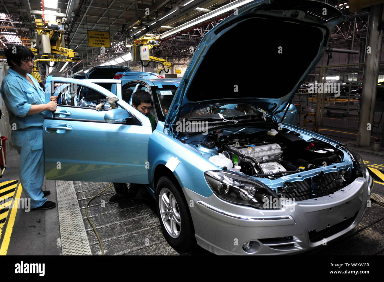 --FILE--Chinese workers assemble a car on the assembly line at the ...