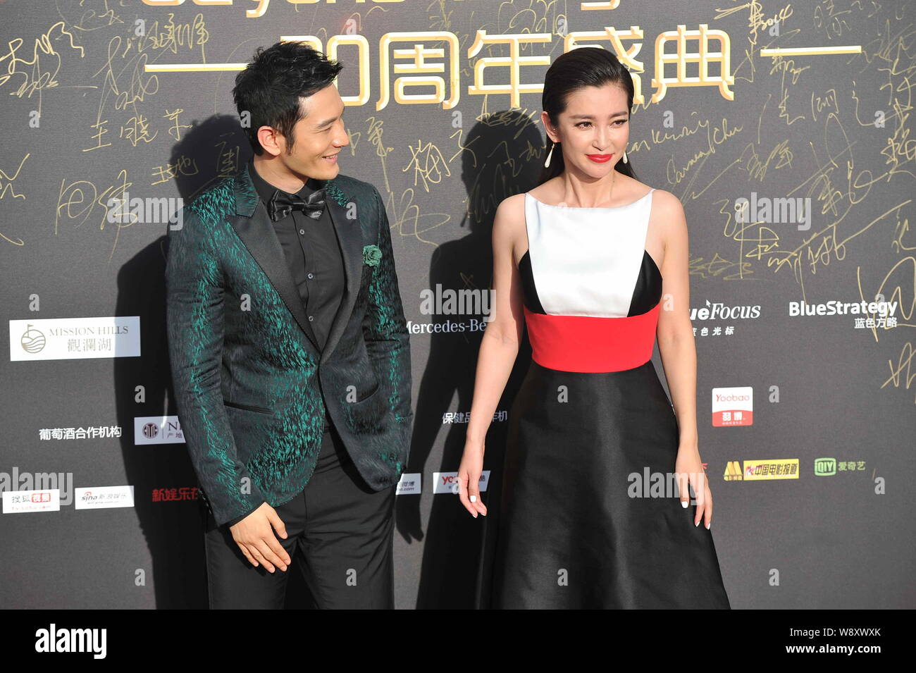 Chinese actor Huang Xiaoming, left, looks at actress Li Bingbing on the