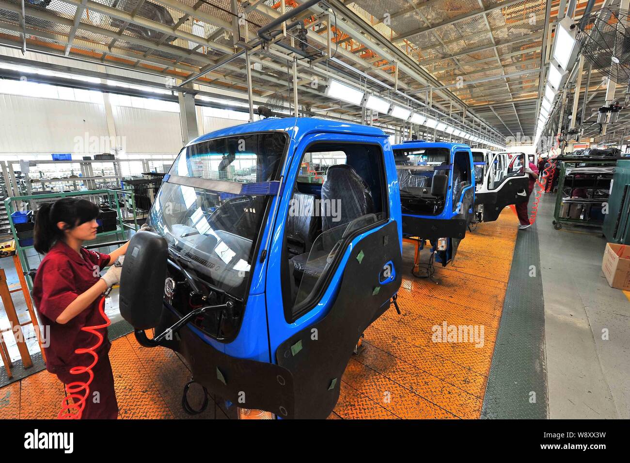 --FILE--Chinese workers assemble trucks on the assembly line at the ...