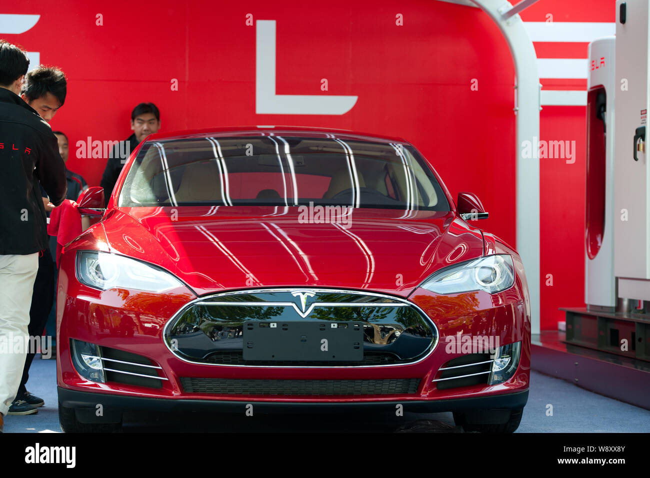 Chinese Workers Dust Off A Tesla Model S Electric Car To Be