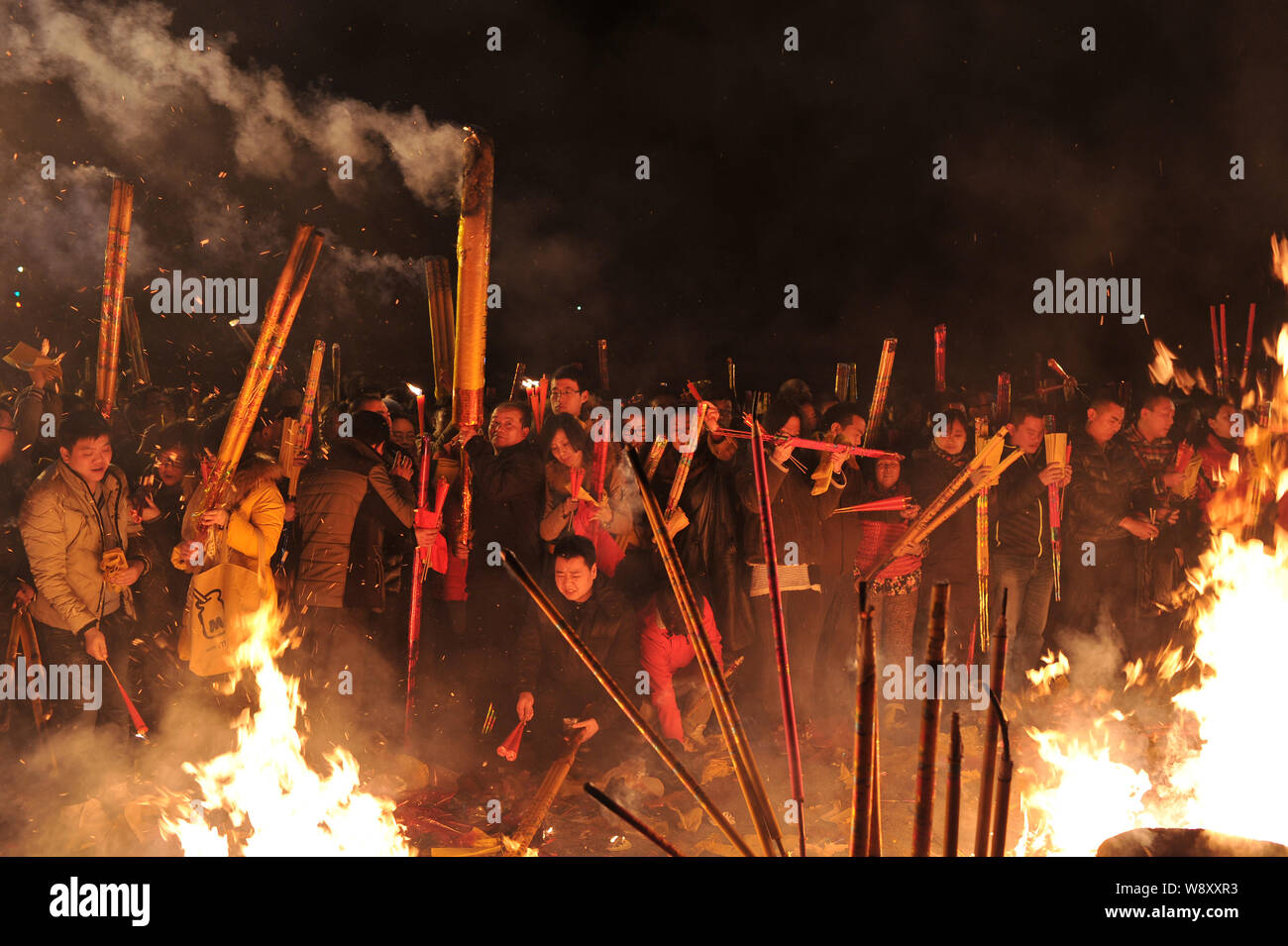 Chinese worshippers burn incense sticks to pray for good fortune and ...