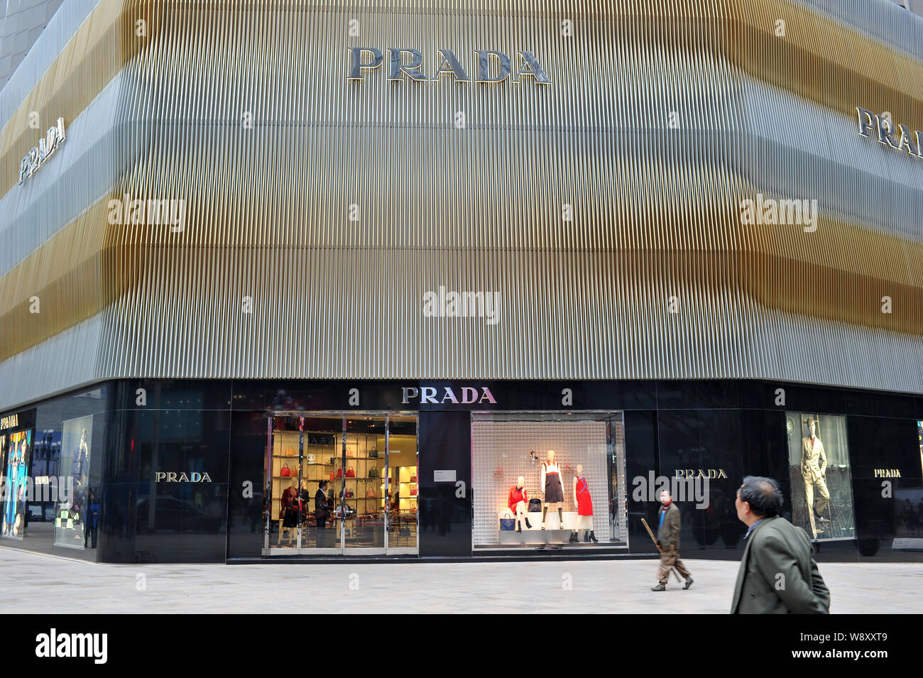 --FILE--Pedestrians walk past a boutique of Prada in Chongqing, China, 27 February 2014.    Italian fashion group Prada SpA, which has been struggling Stock Photo