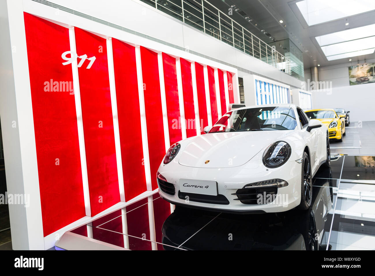 --FILE--A Porsche Carrera 4 and other Porsche cars are displayed at a dealership of Porsche in Beijing, China, 29 June 2014.     Volkswagen AG, Europe Stock Photo