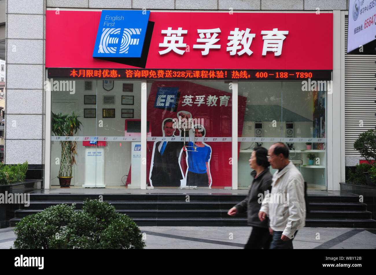FILE--Pedestrians walk past a branch of English training organization EF  Education First in Shanghai, China, 31 October 2011. English learners in  Stock Photo - Alamy