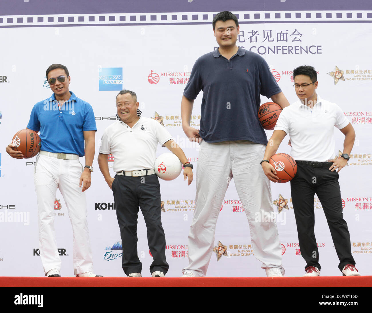 Retired Chinese basketball star Yao Ming, tallest, and Hong Kong actor Eric Tsang, second from left, attend a press conference for the 2014 Mission Hi Stock Photo
