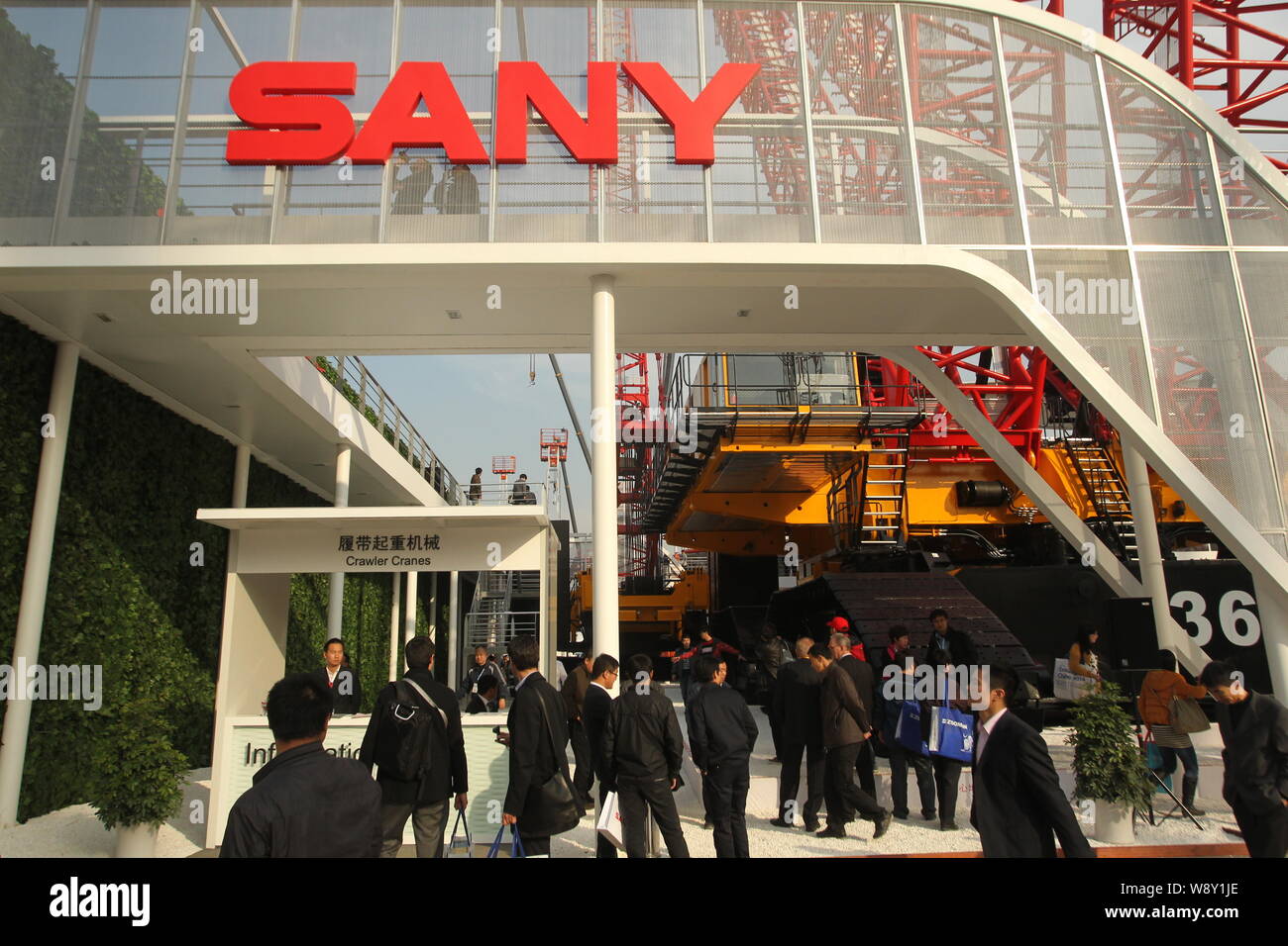--FILE--Visitors look at the construction machineries of Sany Heavy Industry Co. during the 2012 International Trade Fair for Construction Machinery, Stock Photo
