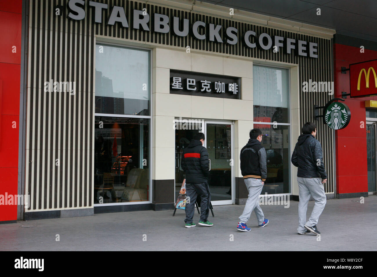 FILEPedestrians walk past a Starbucks Coffee Cafe in Beijing, China