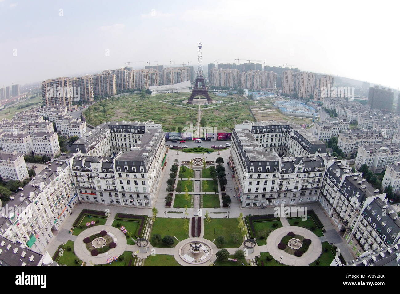 The downsized replication of Eiffel Tower is surrounded by vegetable fields and residential apartment buildings in Tianducheng, a small Chinese commun Stock Photo