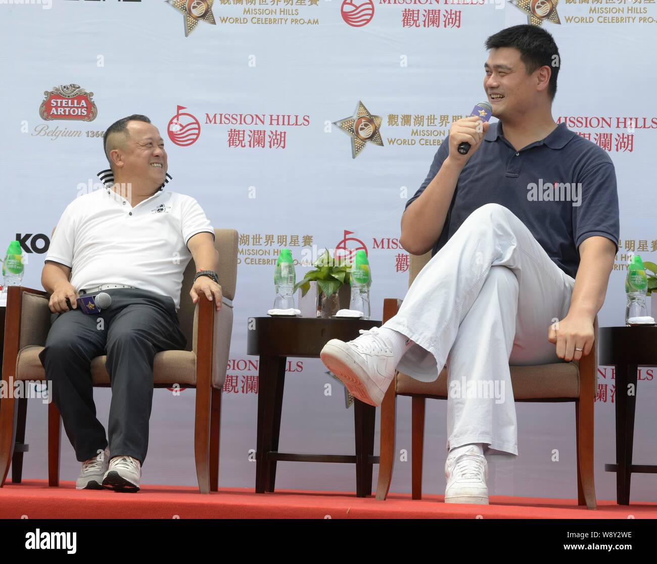 Retired Chinese basketball star Yao Ming, right, and Hong Kong actor Eric Tsang laugh during a press conference for the 2014 Mission Hills World Celeb Stock Photo