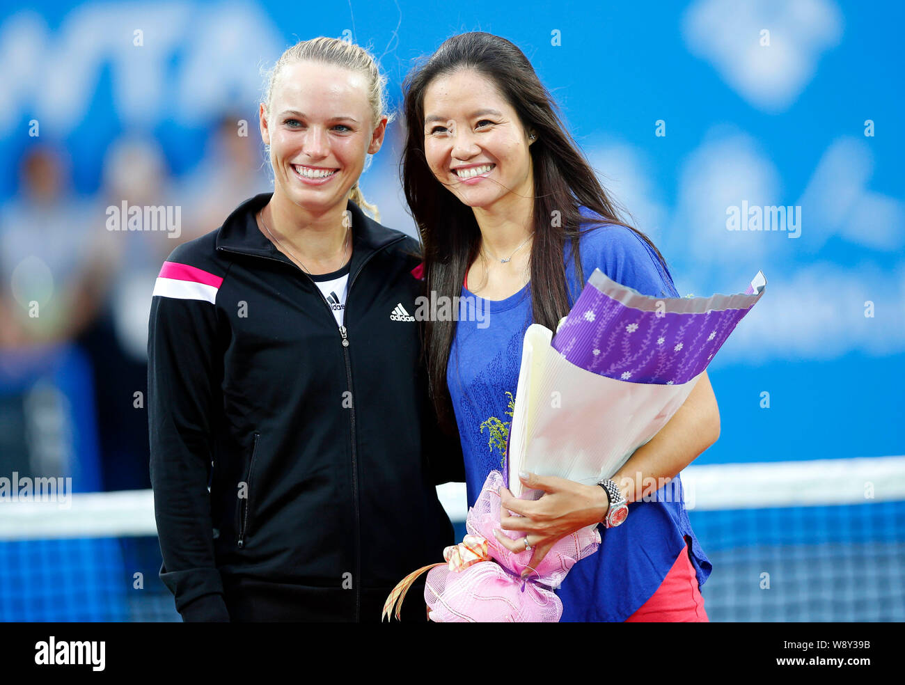 Chinese tennis star Li Na, right, poses with Danish tennis player Caroline Wozniacki during a brief retirement ceremony during the 2014 WTA Wuhan Open Stock Photo
