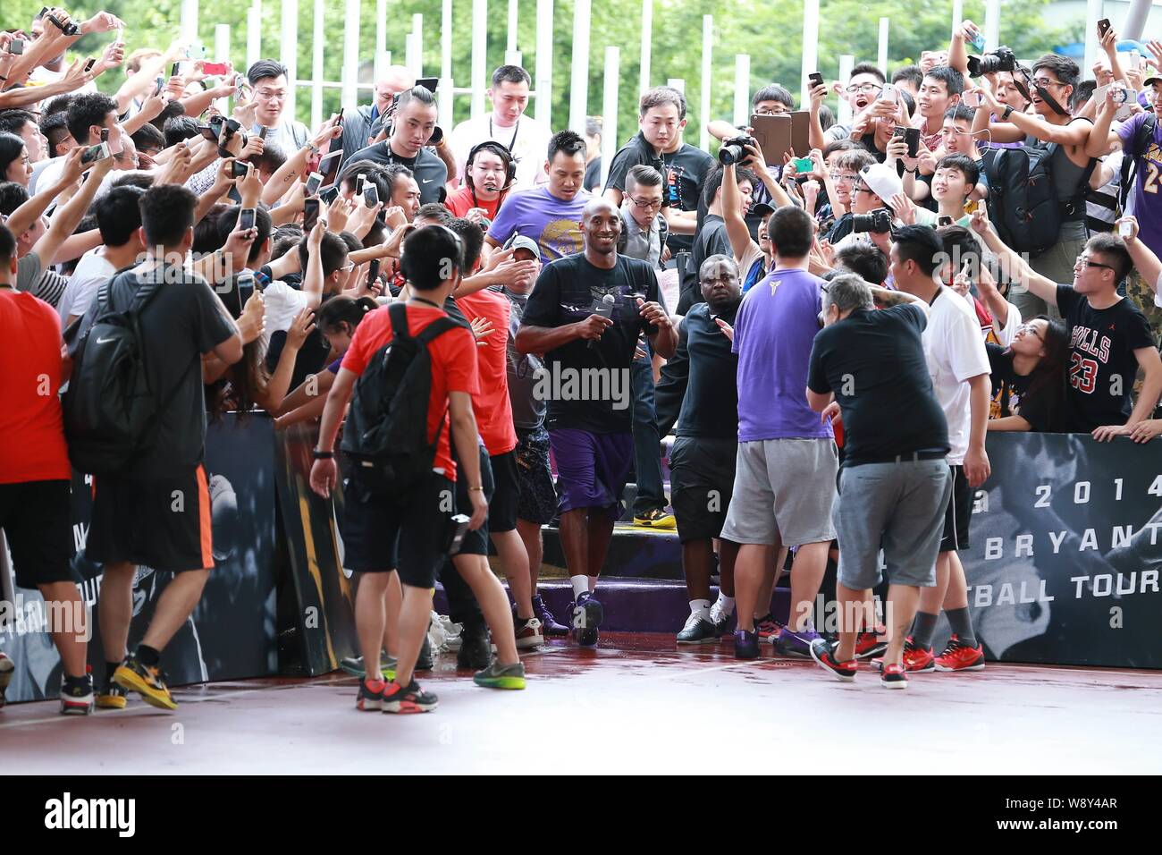 NBA superstar Kobe Bryant, center, arrives for a fan meeting during his China tour in Shanghai, China, 2 August 2014. Stock Photo