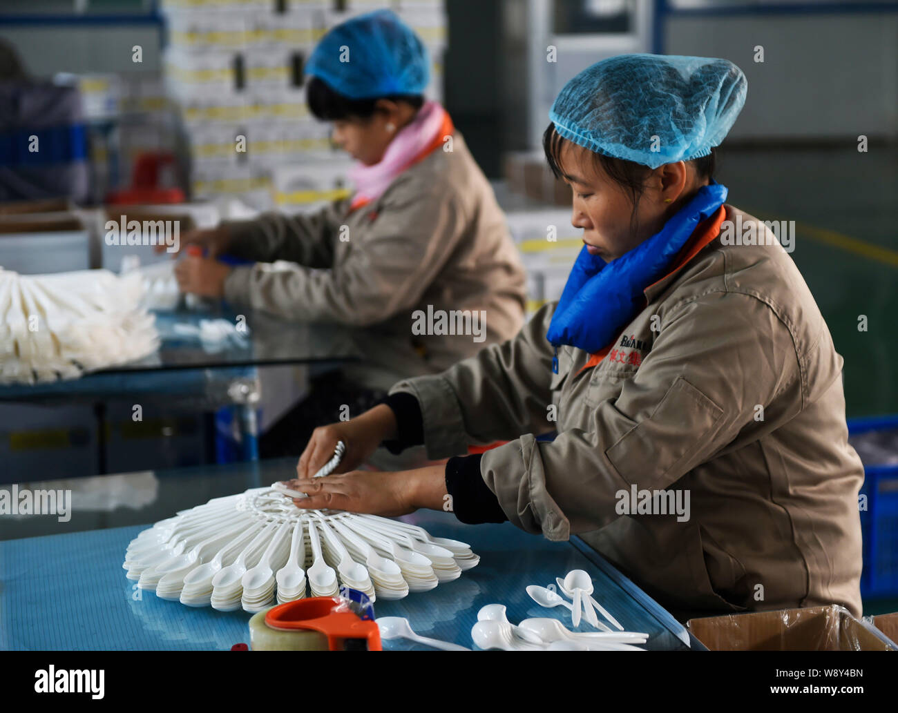 --FILE--Female Chinese workers check degradable disposable spoons to be exported to Southeast Asia at a factory in Handian town, Zouping county, east Stock Photo