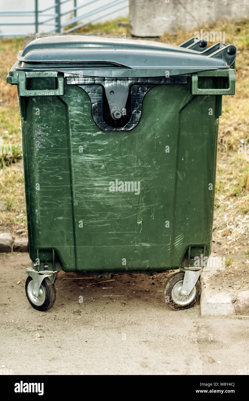 Dumpster in park. One garbage outdoor. View side Stock Photo