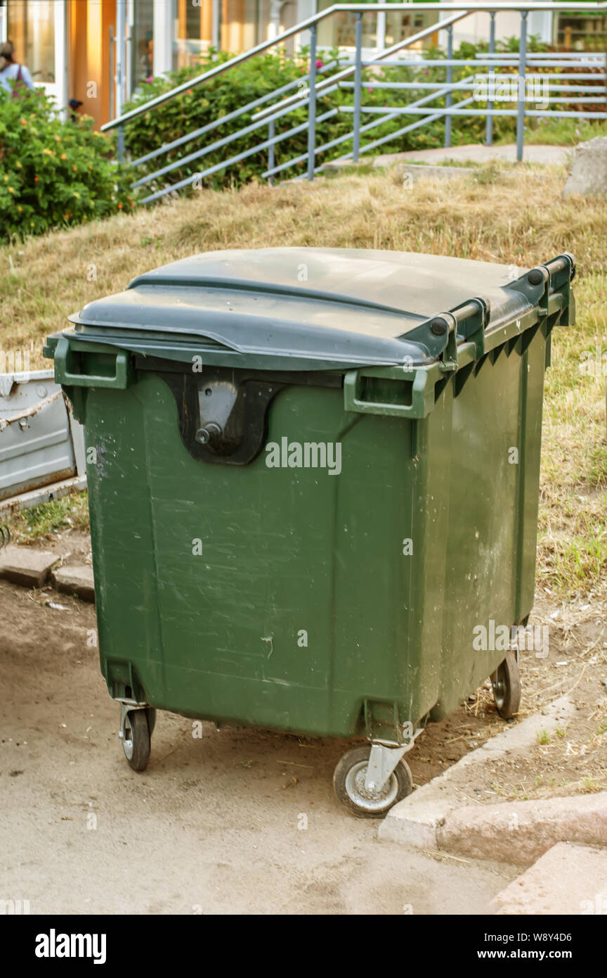 Dumpster in park. One garbage outdoor. Stock Photo