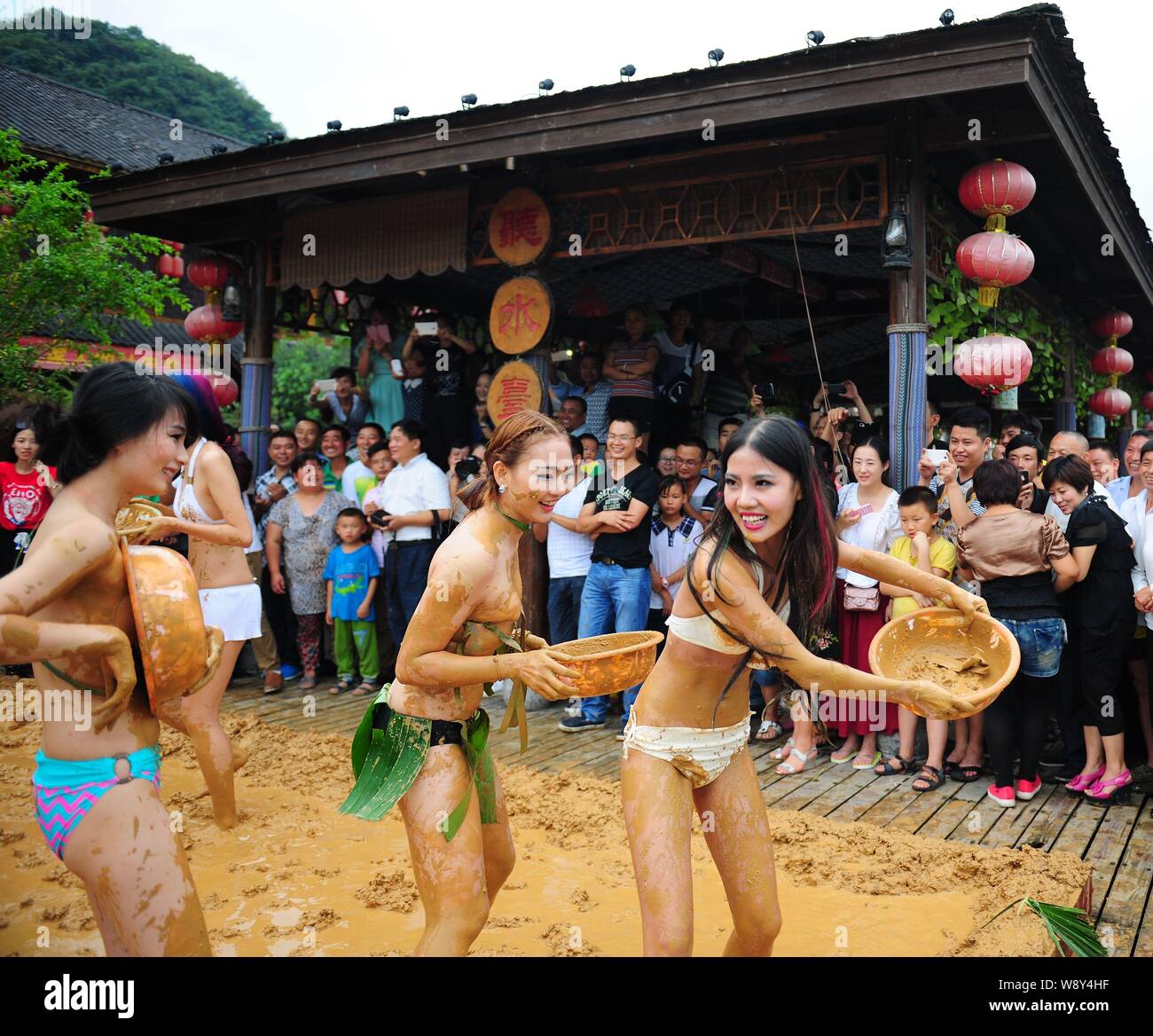 Bikini-dressed women have fun at a mud-wrestling event in a scenic area of Wulingyuan in Zhangjiajie city, central Chinas Hunan province, 10 September Stock Photo