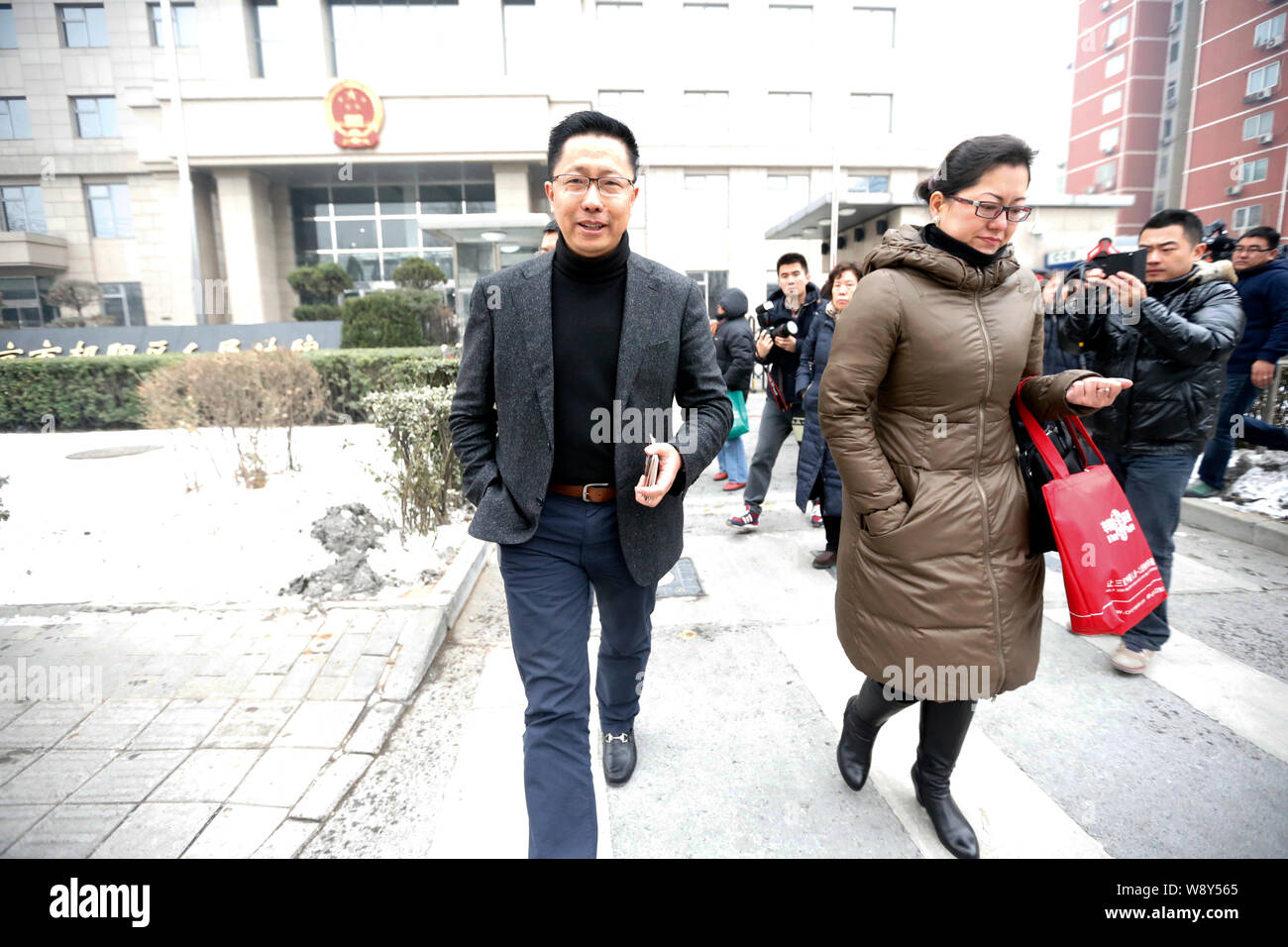 Li Yang, left, founder of Crazy English, walks out of Chaoyang District ...