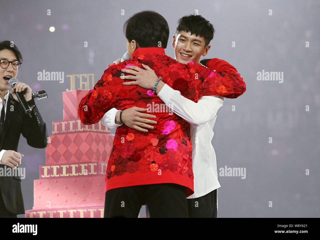 –FILE–Taiwanese actor Kai Ko (R) hugs Jaycee Chan’s father Jackie