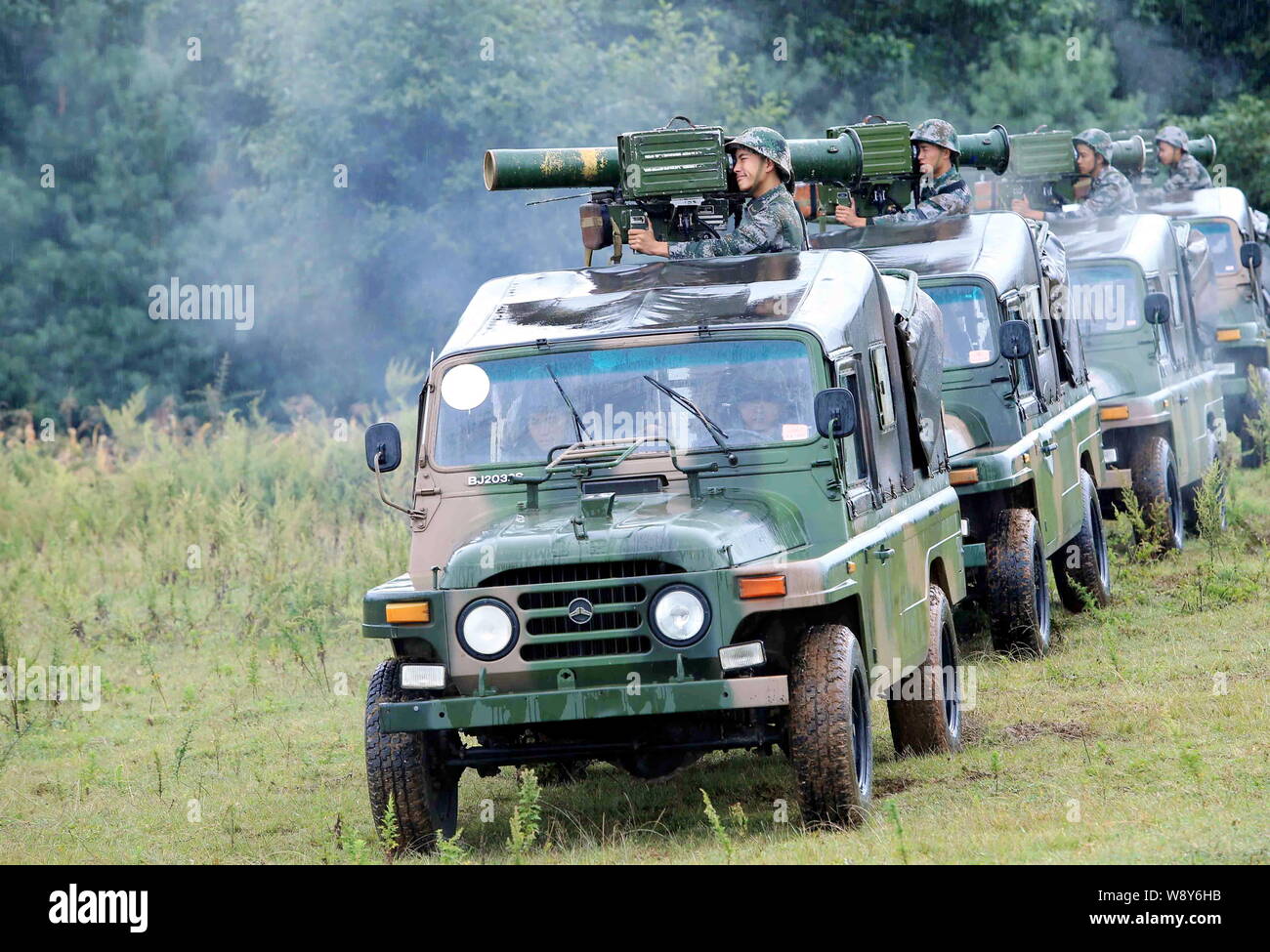 --FILE--Chinese PLA (People's Liberation Army) soldiers launch anti-tank missles on jeeps during a military drill in southwest China's Sichuan provinc Stock Photo