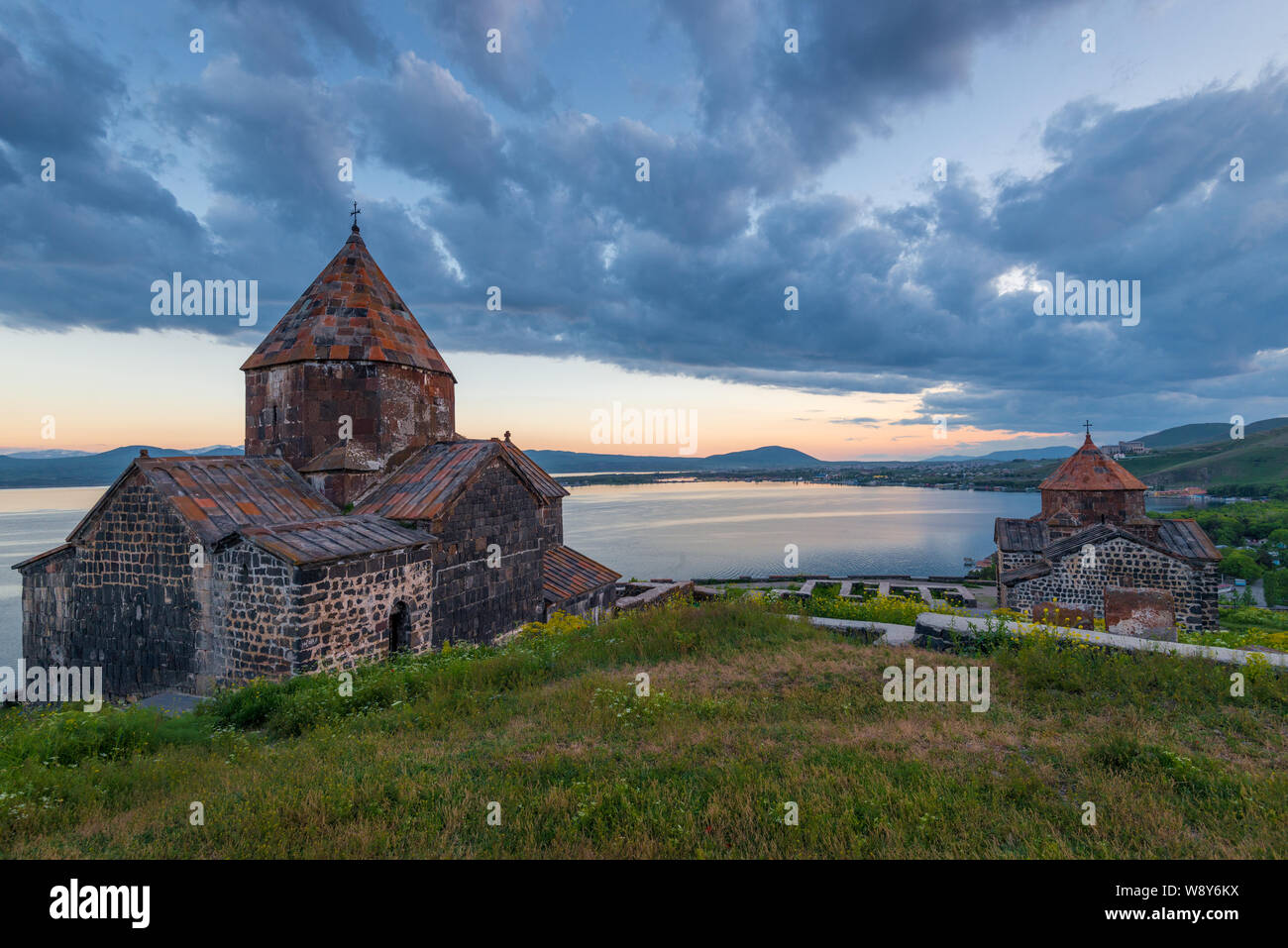 Dramatic view of the sights of Armenia - Lake Sevan and the monastery of Sevanavank at sunset Stock Photo