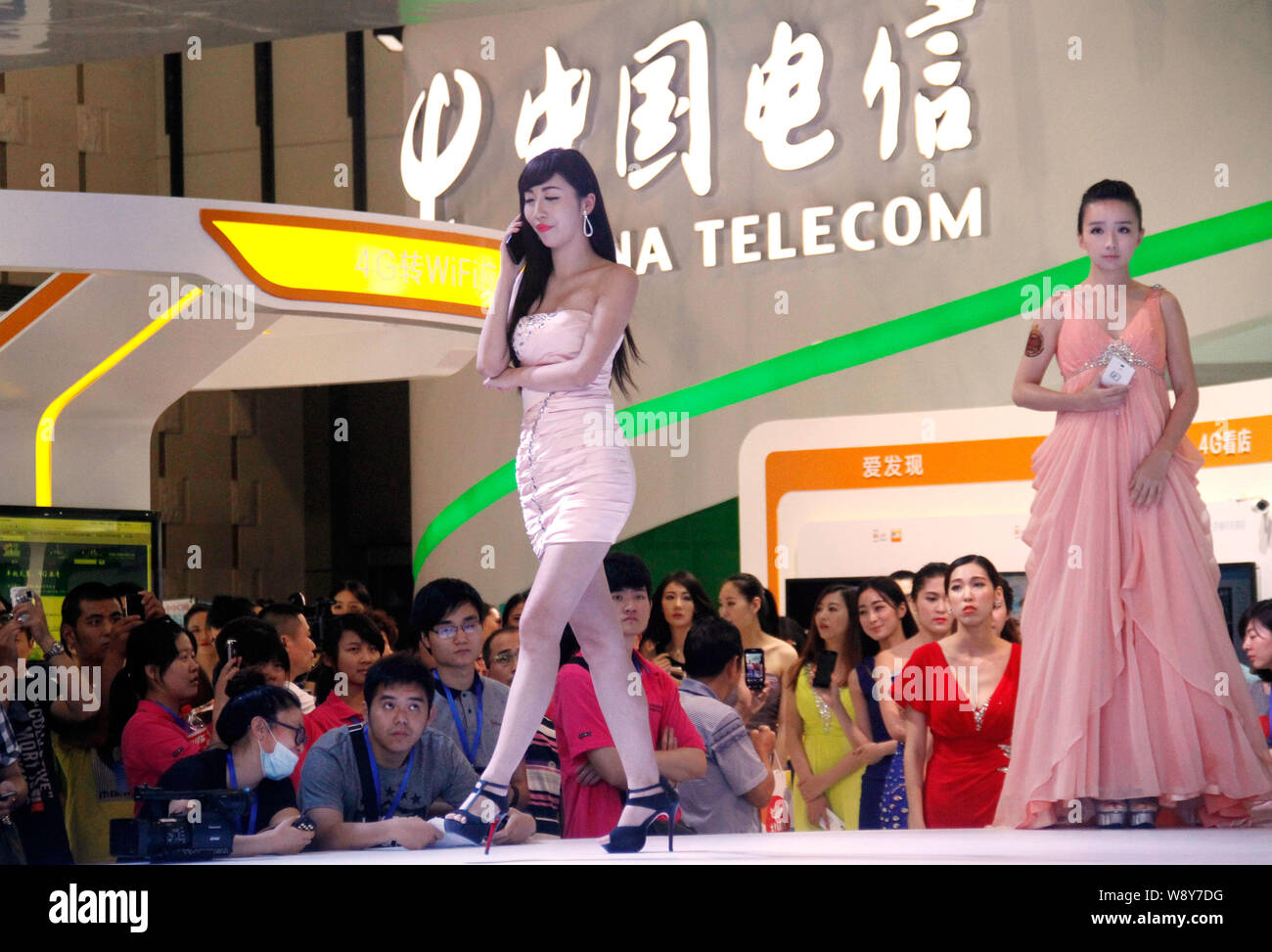 Models display smartphones at the stand of China Telecom during the 2014 Tianyi Mobile Fair & Mobile Internet Forum in Nanjing, east Chinas Jiangsu pr Stock Photo