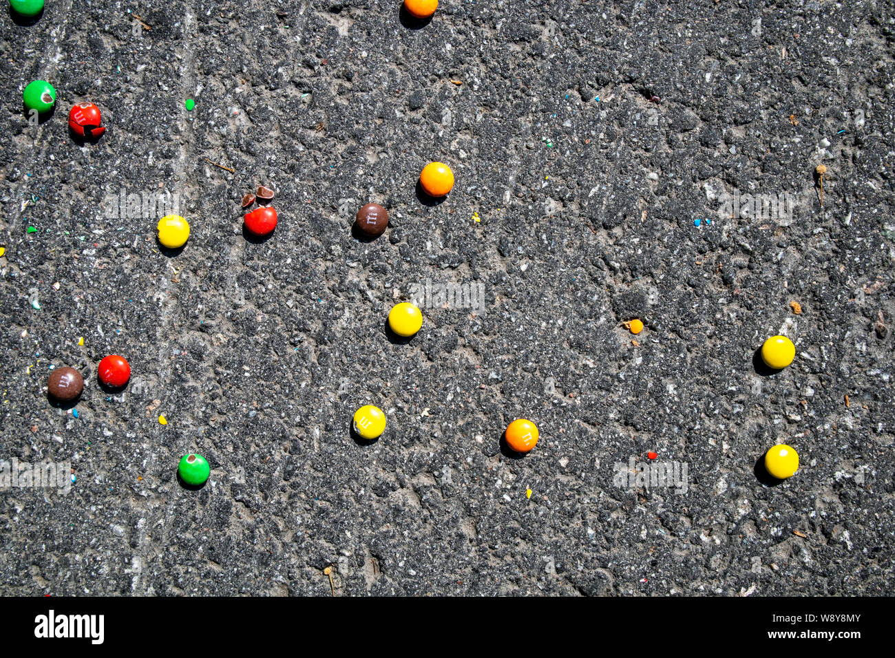 M&M candies dropped on ground outdoors Stock Photo Alamy
